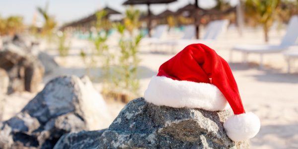 Santa hats on the beach. Christmas and New Year holidays in the concept of warm countries.